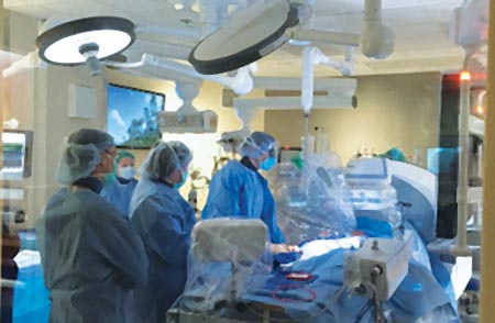 Photo of a surgery taking place in the Hybrid Room at Christian Hospital